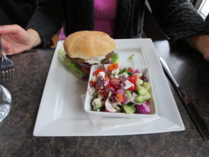 Lamb burger with a greek salad